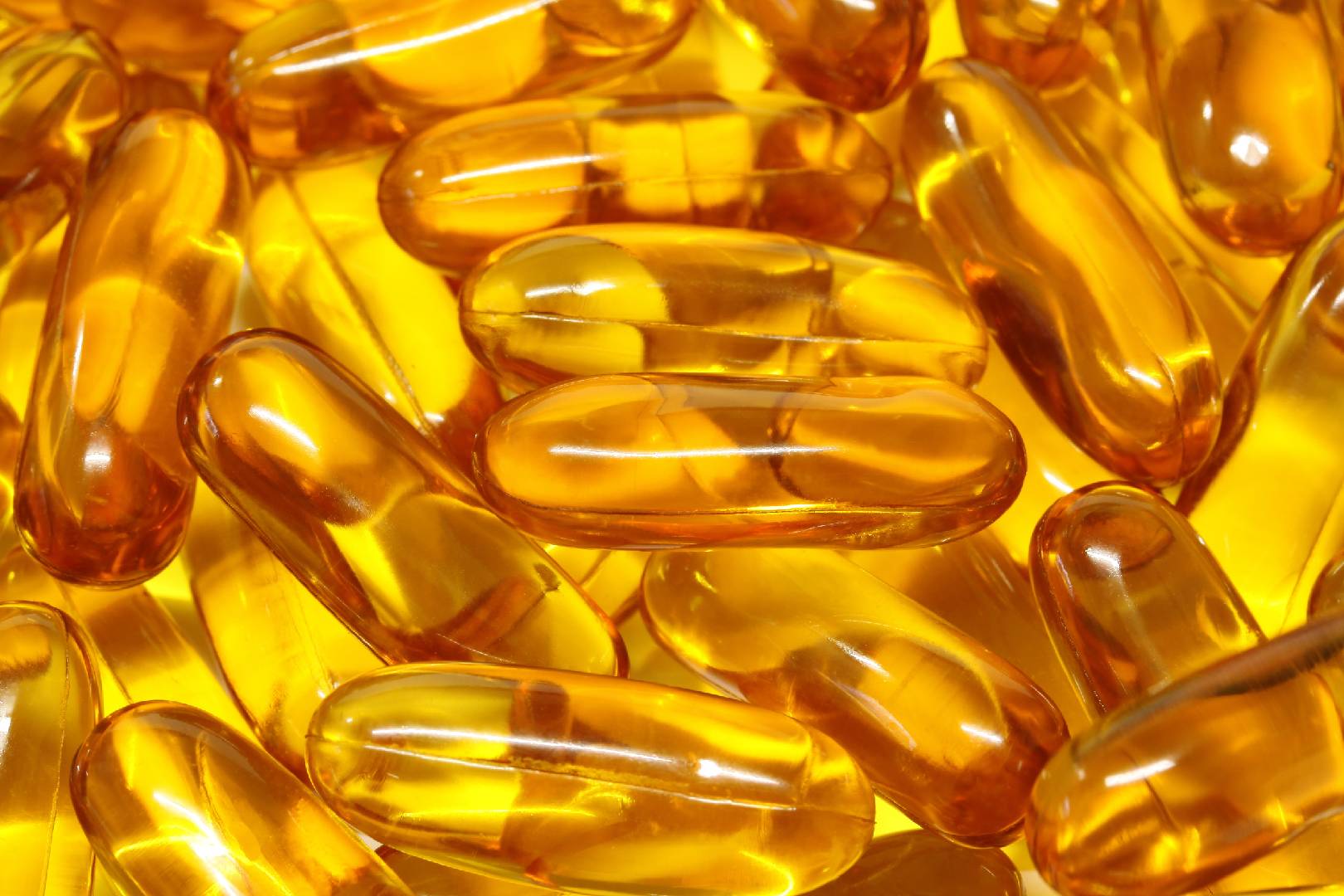 "Close-up of golden softgel capsules, typically used as Omega-3 supplements.